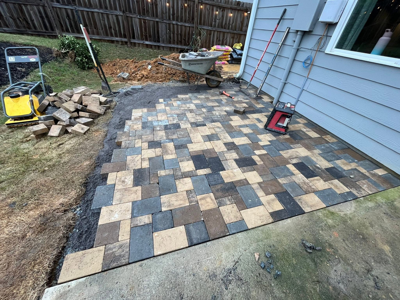 Drainage and grading work alongside stone terrace